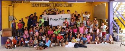 A group of Projects Abroad volunteers and children on our conservation and community work project in Belize for high school students A group of volunteers takes part in conservation and community work in Belize for teenagers